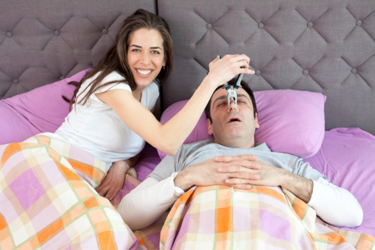young woman trying to stop snoring husband
